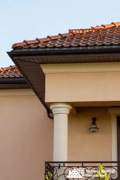 A beautiful house featuring red tile roofing, expertly installed by skilled professionals.