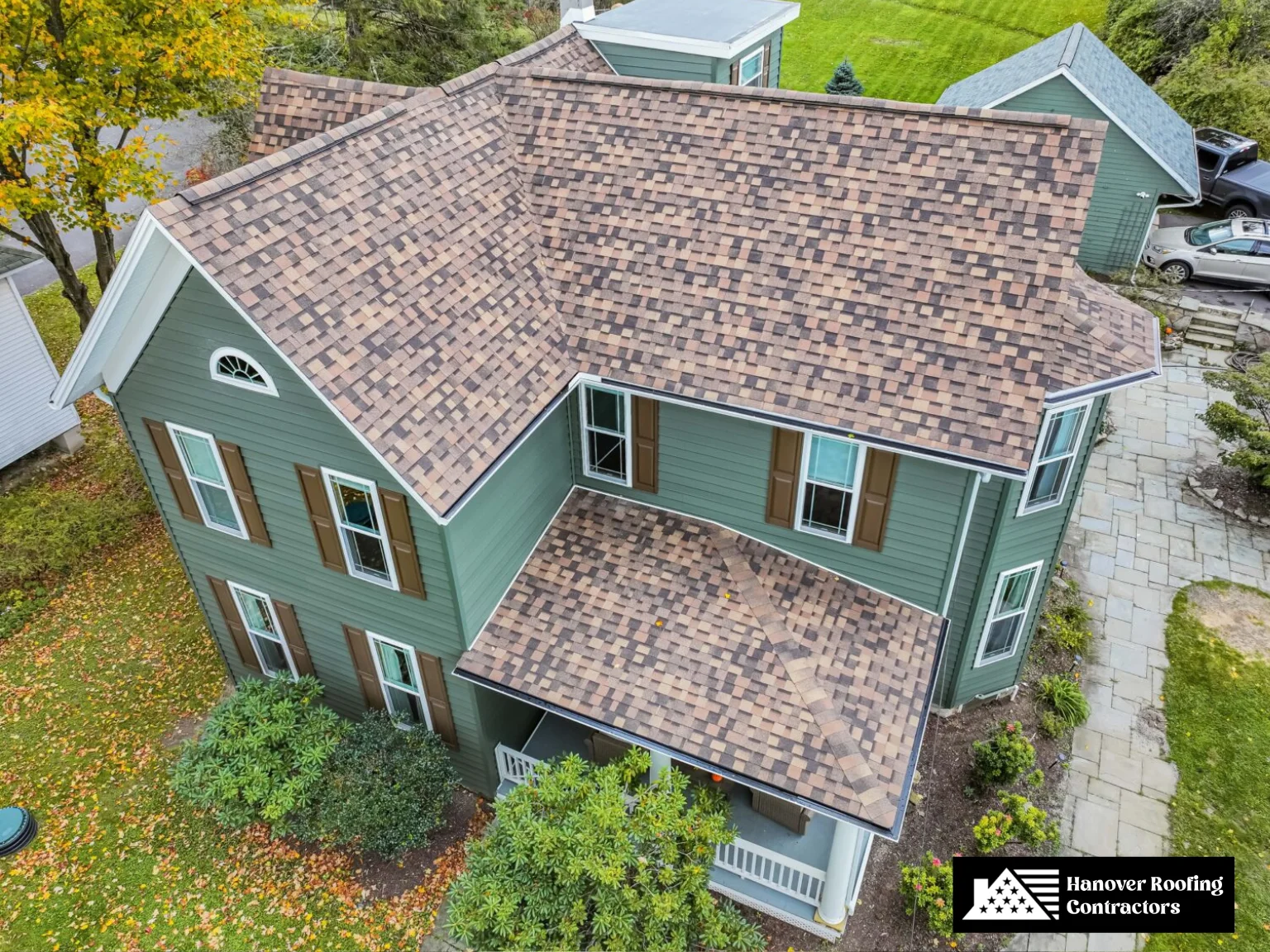 Classic home with a multi-colored asphalt shingle roof installation.